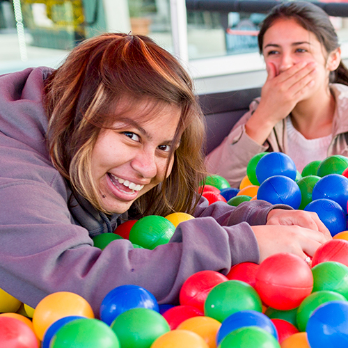 Students smile in the USU Ball Pit, Spring 2016