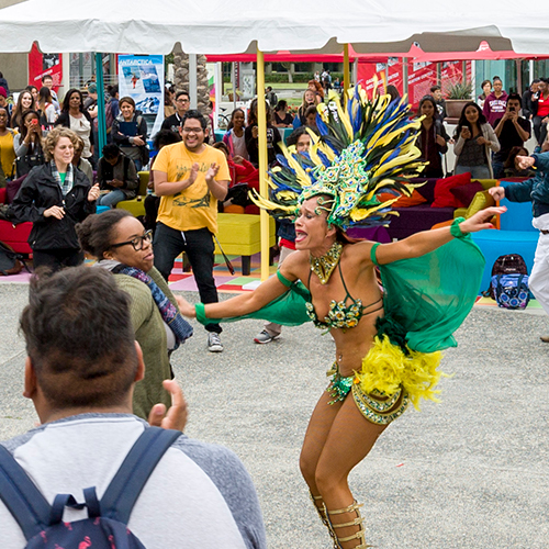 Students dance with Brazilian dancers, at the USU CARNAVAL event, Spring 2016