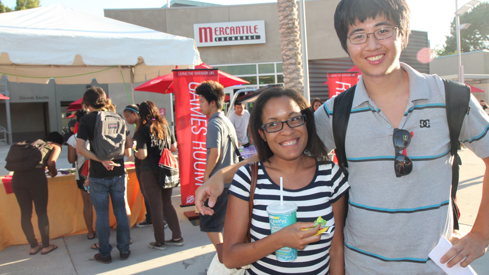 Students stand together smiling in the Plaza del Sol, USU during the fall 2012 Matafest event