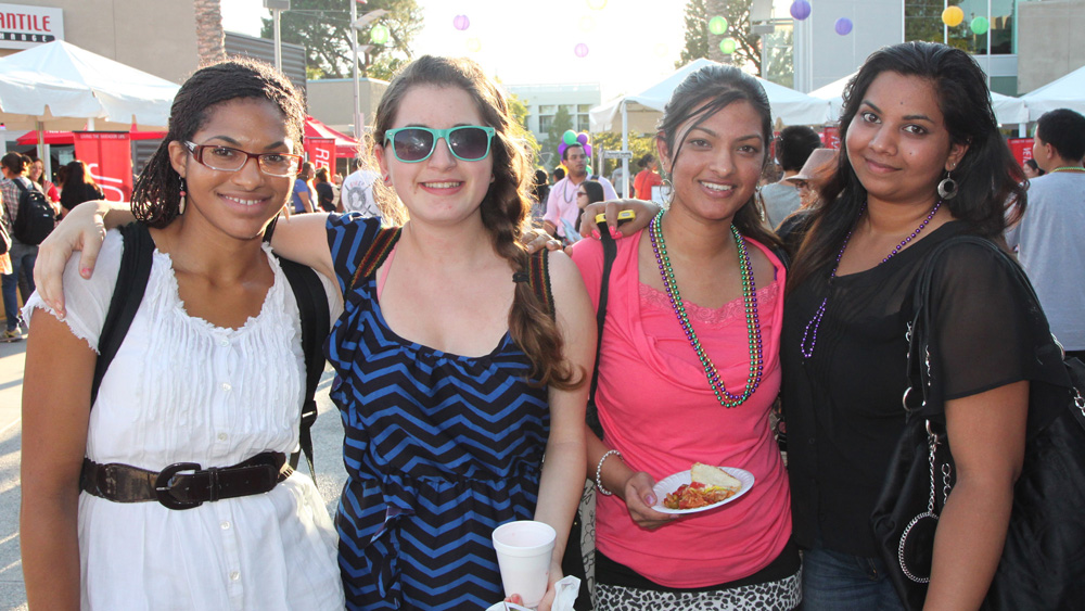 Four students pose together in the Plaza del Sol, USU during the fall 2012 Matafest event