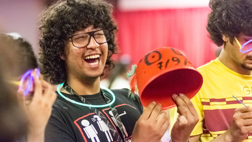 A student laughs while holding his Craft Corner creation during the fall 2012 Matador Nights event