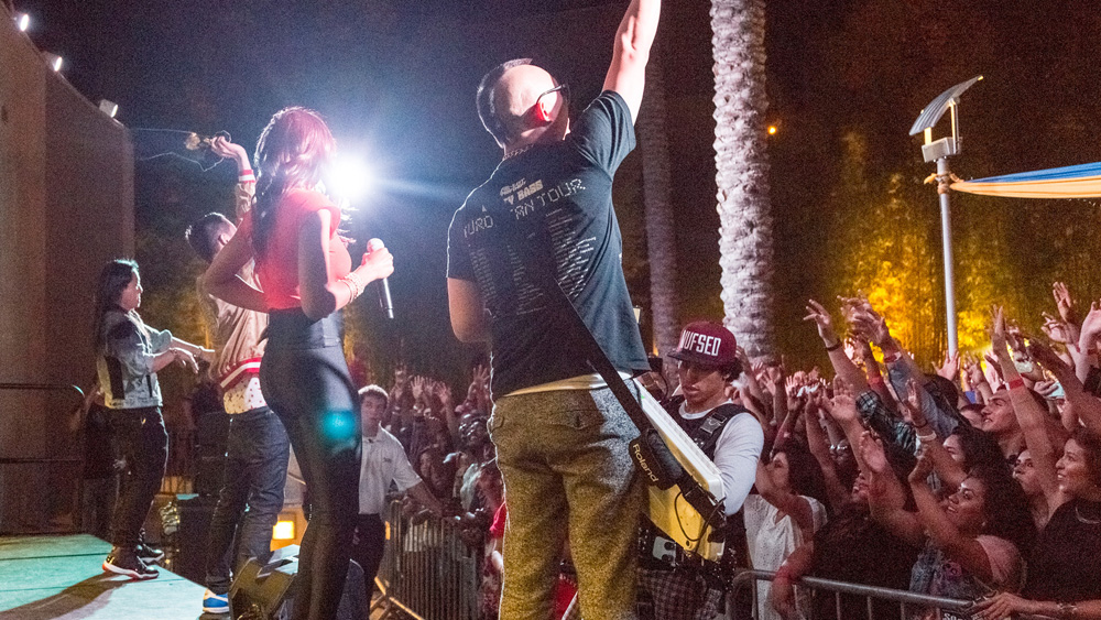 The performers from Far East Movement take the stage while the crowd goes wild in the background at the fall 2012 Matador Nights event
