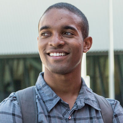 Male student smiling in front of the SRC