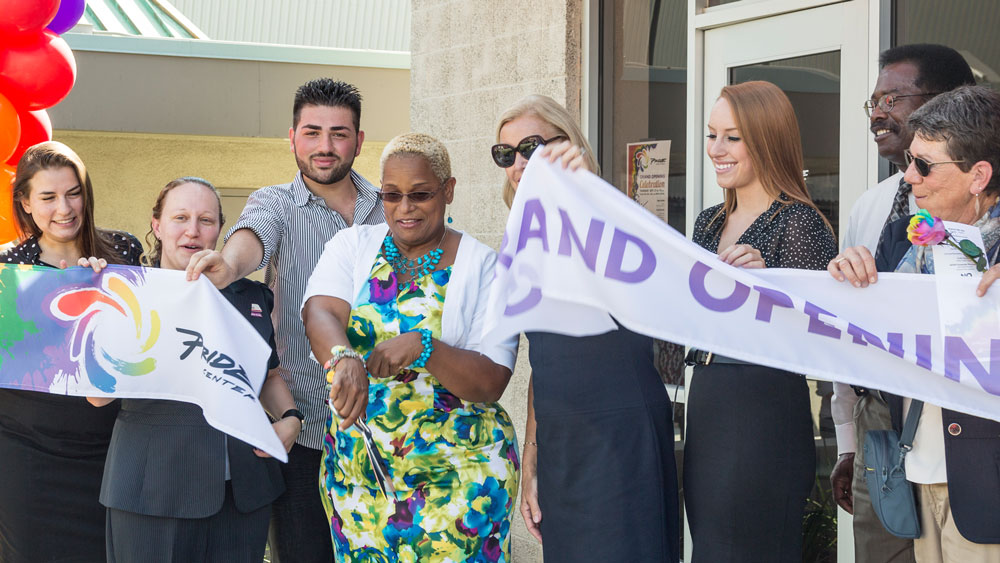 Students, campus staff, campus administrators and USU staff cut the ribbon during the Pride Center Grand Opening