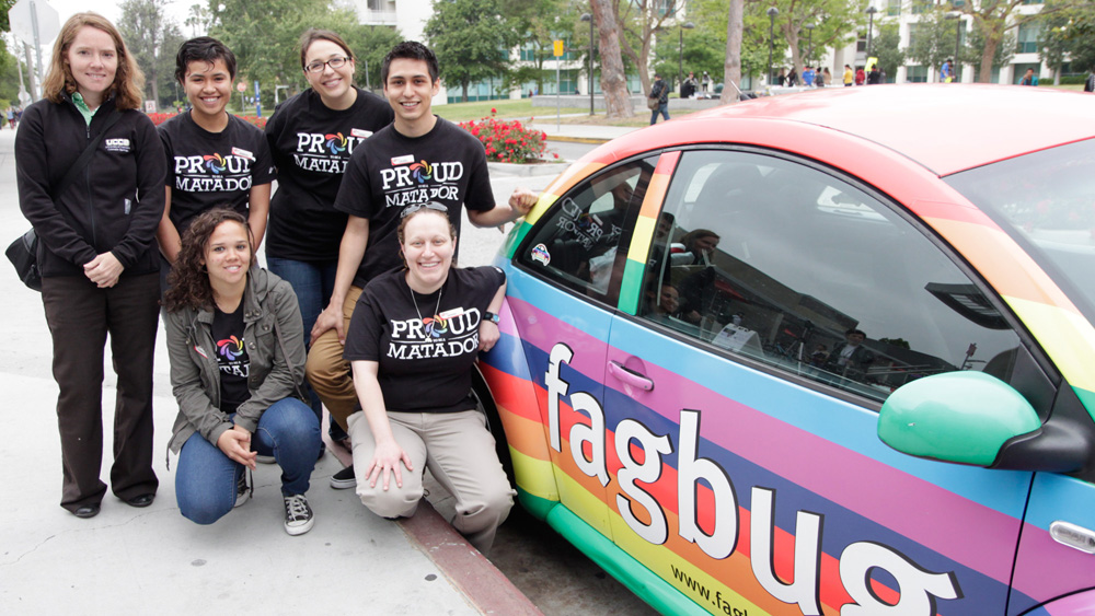 Pride Center staff members pose with Erin Davies and the FagBug during the FagBug event which brought Davies and the car to campus