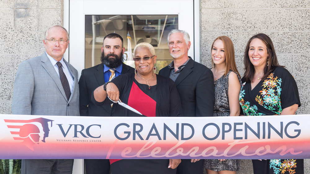 Students, veterans, campus aministrators, USU staff and board members cut the ribbon at the VRC Grand Opening