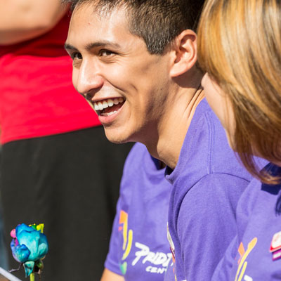Student smiling at the Pride Center Grand Opening