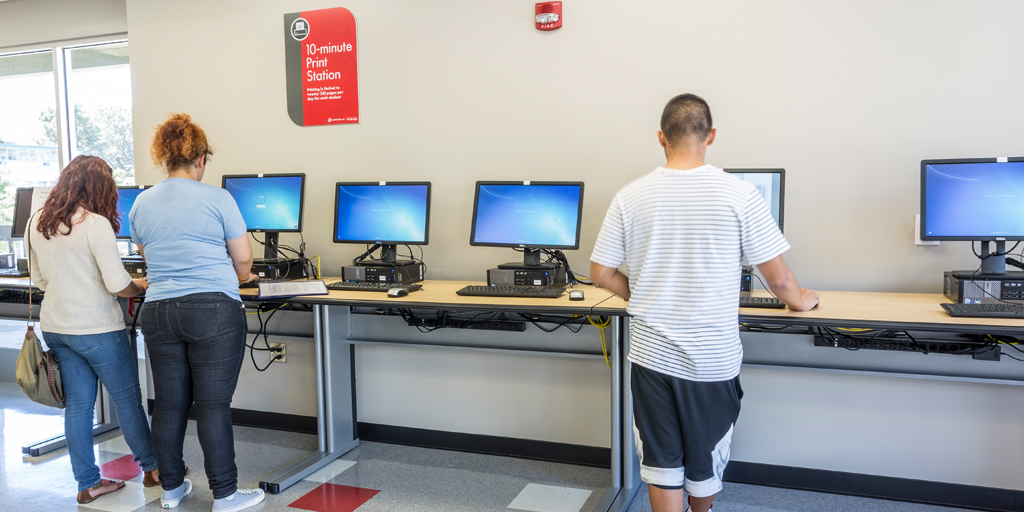Students use the 10-minute print stations in the USU Computer Lab