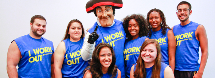 A group of students who participated in the I Work Out member incentive program pose with Matty the Matador
