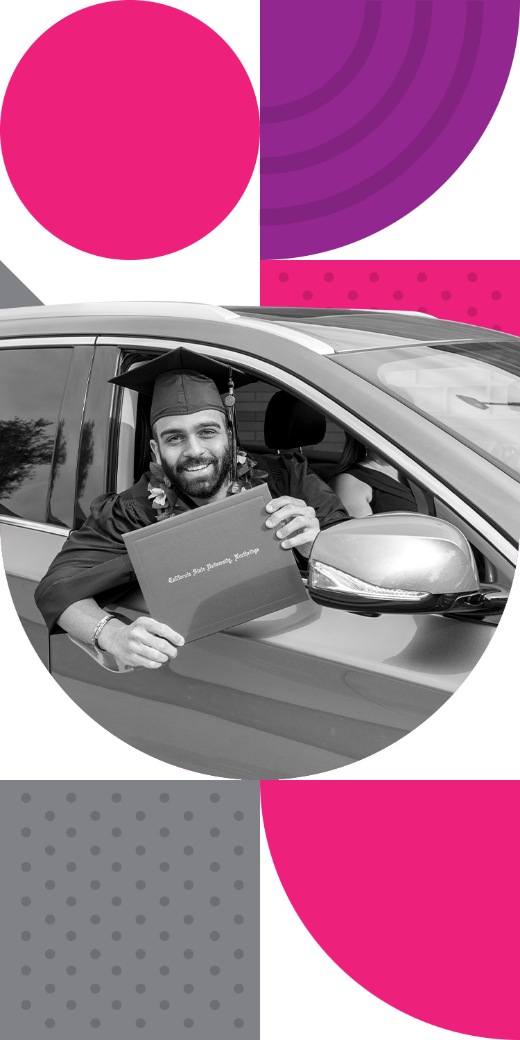 CSUN student showing diploma cover from inside a car